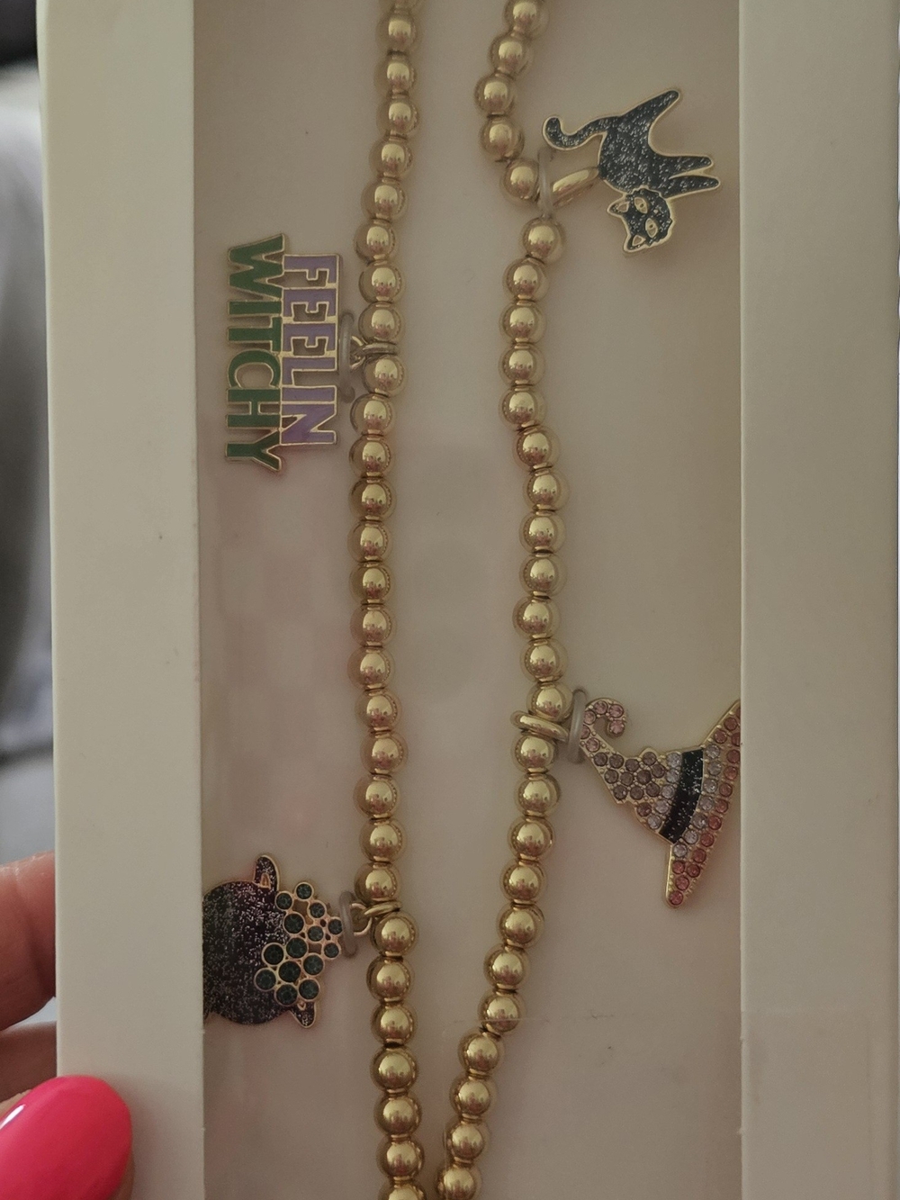 BaubleBar Gold Beaded Phone Charm Wristlet with Enamel Accents